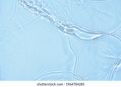 De-focused blurred transparent blue colored clear calm water surface texture with splashes and bubbles. Trendy abstract nature background. Water waves in sunlight with copy space. - Shutterstock ID 1964704285