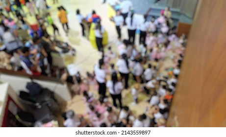 Defocused And Blurry, Top View Of Teacher And Students At Hall Of School With Blur Effect.