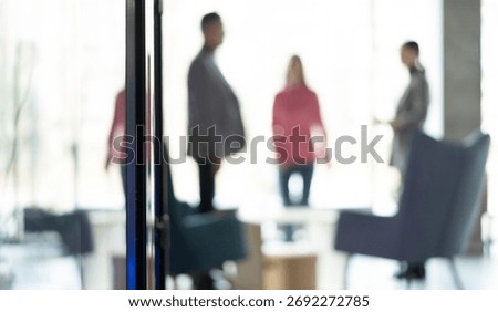 Defocused bokeh effect positive concept background of unrecognizable people business team meeting of professionals corporate startup