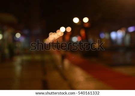 Defocused bokeh light and red carpet for the festive event, night street outdoors background