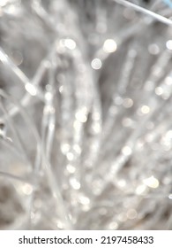 Defocused bokeh light from wet strings for backgound and texture