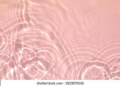 de-focused. Closeup of pink transparent clear calm water surface texture with splashes and bubbles. Trendy abstract summer nature background. Coral colored waves in sunlight. - Shutterstock ID 1833870550