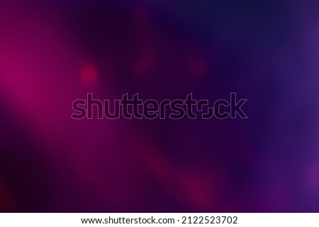 Defocused color glow. Neon background. Ultraviolet soft texture. Blur fluorescent pink purple light reflection on dark abstract copy space wallpaper.