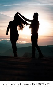 Defocused composition shoot of dancing young couple silhouette during sunset in Cappadocia. 