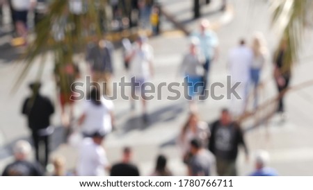 Defocused crowd of people, road intersection crosswalk on The Strip of Las Vegas, USA. Anonymous blurred pedestrians on walkway in crowded urban downtown. Unrecognizable american citizens in sin city.