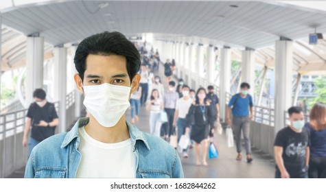 Defocused Crowd Wearing Medical Masks For Virus Protection And Walking In Walkway, Blurred Background, Coronavirus, China Covid-19 Virus Epidemic, Pandemic, Outbreak And Air Pollution Concept