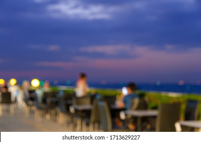 Defocused Dining Table Restaurant Poolside On The Roof Top With Twilight Skyline