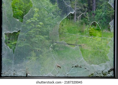 Defocused Dirty Broken Window With A Hole In The Center, Sharp Pieces Of Glass Sticking Out, Concept Shot, Smash With A Stone, Military Operations, Destruction Of Buildings From Bombing 