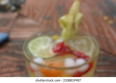 Defocused, A Drink With Starfruit As A Garnish