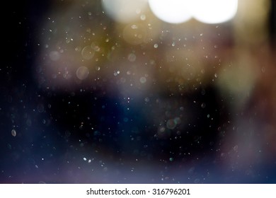 Defocused Dust Particles Against Sun, Shimmering Bokeh Effect.