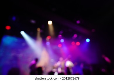 Defocused entertainment concert lighting on stage, blurred disco party.