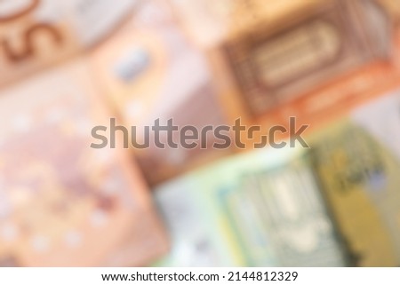 Defocused euro banknotes of different denominations. Financial, savings and exchange business background background.