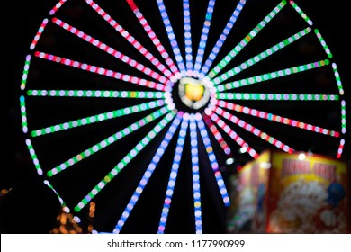 Defocused Faires Wheel At Night Showing Off Its Beautiful Colors In Santa Cruz, California.