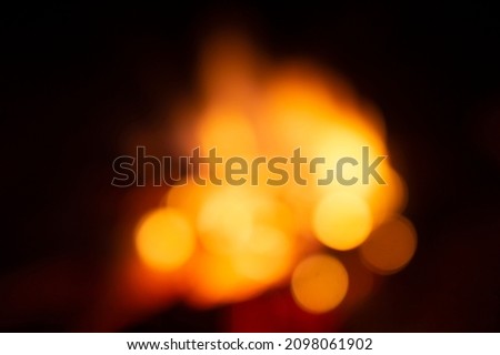Defocused fire background, blurred orange fire flames in the night teture