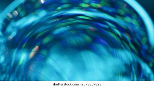 Defocused flicker. Strobe rotation. Rays pass through round faceted lens. Blue stroboscopic flashlight. Refracting effect background. Colorful festive shimmer.