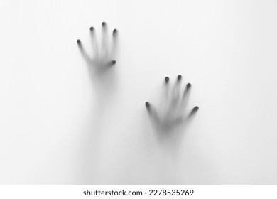 Defocused hand silhouette behind frosted glass in black and white mode, halloween concept - Powered by Shutterstock