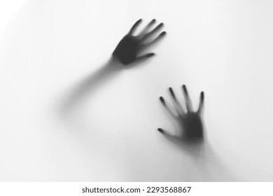 Defocused hand silhouette behind frosted glass in black and white mode, halloween concept
 - Powered by Shutterstock