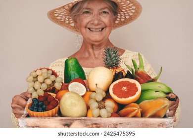 Defocused happy senior woman in straw hat holding basket full of fresh exotic fruit, healthy lifestyle concept - Powered by Shutterstock