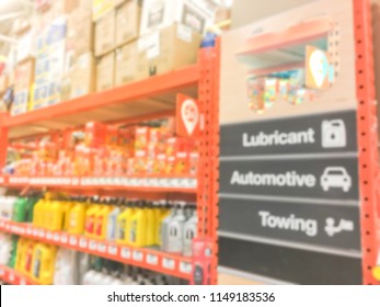 Defocused Home Improvement Retailer Store With Racks Of Lubricant, Automotive, Towing, Garage Organization. Blurred Image Background Of Large Hardware Store In America