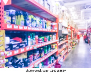 Defocused Home Improvement Retailer Store With Racks Of Lubricant, Automotive, Towing, Garage Organization. Blurred Image Background Of Large Hardware Store In America