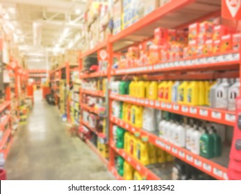 Defocused Home Improvement Retailer Store With Racks Of Lubricant, Automotive, Towing, Garage Organization. Blurred Image Background Of Large Hardware Store In America