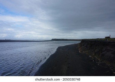 Defocused Image of black clouds overshadowing the estuary of the coast of Samas Samas, Bantul. Indicates that heavy rain will occur. Captured in a low light photo on a cloudy day. - Shutterstock ID 2050330748
