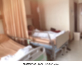 Defocused Image, Elderly Patients Lying On Bed Waiting For The Doctor In Emergency Room, At Hospital. Selective Focus.