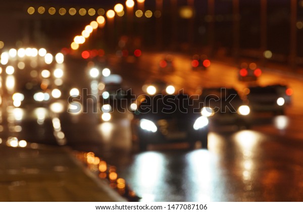 Defocused image\
of hard night for drivers. Big traffic in the city. In the summer\
urban highway filled cars. To be late. For greeting card design,\
postcard template, guide,\
poster.