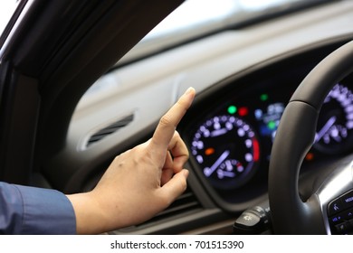 De-focused Index Finger/ Steering Wheel And Dashboard