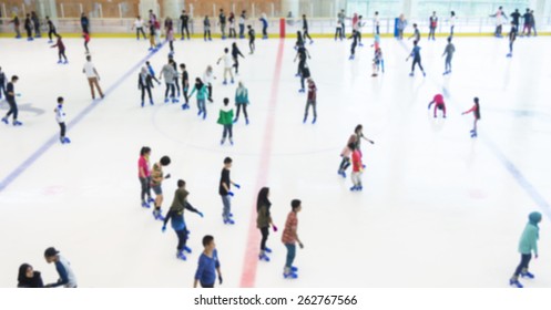 Defocused Of Indoor Ice Skating Park With Skating People.