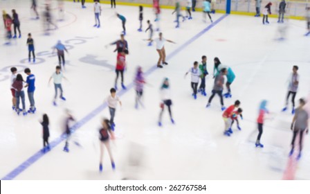 Defocused Of Indoor Ice Skating Park With Skating People.