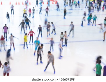 Defocused Of Indoor Ice Skating Park With Skating People.