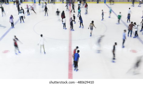 Defocused Of Indoor Ice Skating Park With Skating People.