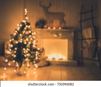 Defocused interior with christmas tree with bokeh lights and a fireplace - Powered by Shutterstock