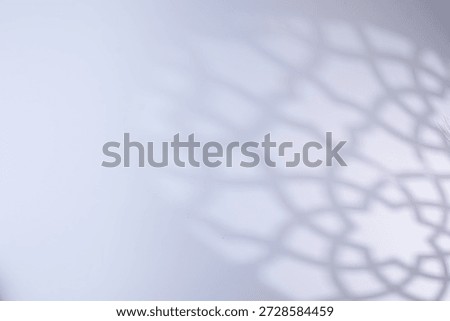 Defocused of Islamic shadow background with soft geometric mosque pattern on bright white surface, Suitable for Ramadan, Eid Mubarak, and Muslim greeting designs