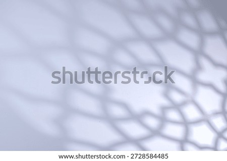 Defocused of Islamic shadow background with soft geometric mosque pattern on bright white surface, Suitable for Ramadan, Eid Mubarak, and Muslim greeting designs