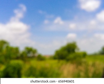 defocused landscape grass field with blue sky