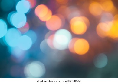 Defocused Of Light Blue And Yellow LED Light On Black Background. Bokeh Photo Of LED Light. Blue And Yellow Bokeh. Orange And Teal Bokeh