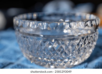 Defocused macro abstract texture background view of a small lead crystal bowl surface with diamond facet cuts