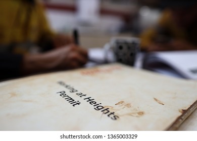 Defocused Of Miner Setting On The Chair Written Job Hazard Analysis (JSA) Working At Height Permit With JSA Templates Forms On The Table Perth, Australia