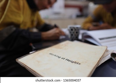 Defocused Of Miner Setting On The Chair Written Job Hazard Analysis (JSA) Working At Height With JSA Templates Forms On The Table Perth, Australia