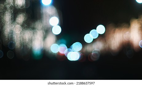 Defocused Night Street Lights. Bokeh Street Lights From Cars In The City.