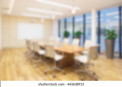 Defocused Office Background Of A Board Room With Rustic Wooden Flooring,  Meeting Table And Eames Chairs.