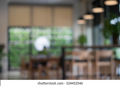 Defocused Office Background Of A Board Room With Rustic Wooden Flooring, Meeting Table And Eames Chairs