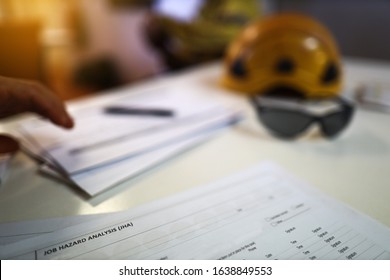 Defocused Personal Protective Equipment Safety Helmet Head Protection Placing On Table Worker Organising Safe Risk Assessment Job Safety Analysis Prior Performing High Risk Paperwork At The Foreground