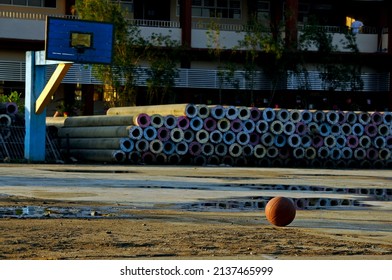 Defocused photo of Rubber basketball in the middle of the court and under construction