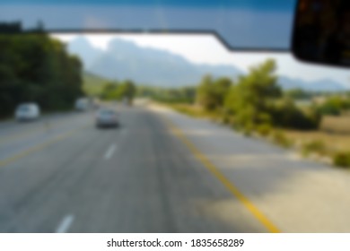 Defocused Photography, View From The Bus Window On The Road. Blurred Background Copy Space For Your Design