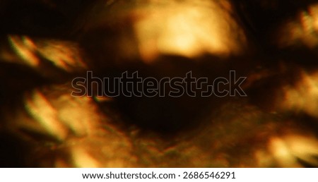 Defocused shiny flare. Gradient texture. Warm orange yellow color radiant glow on visual optical bokeh light glisten art dark black background.
