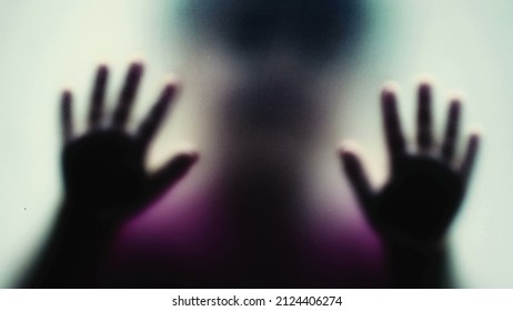 Defocused Shot Of A Child Behind Glass Feeling Stuck Abusive Concept