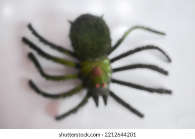 Defocused Of Spider Toy Isolated On White Background